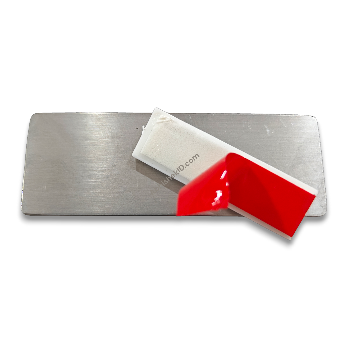 Close-up view of 40x13mm self-adhesive badge pin mechanism for plastic ID badges and DIY crafts.