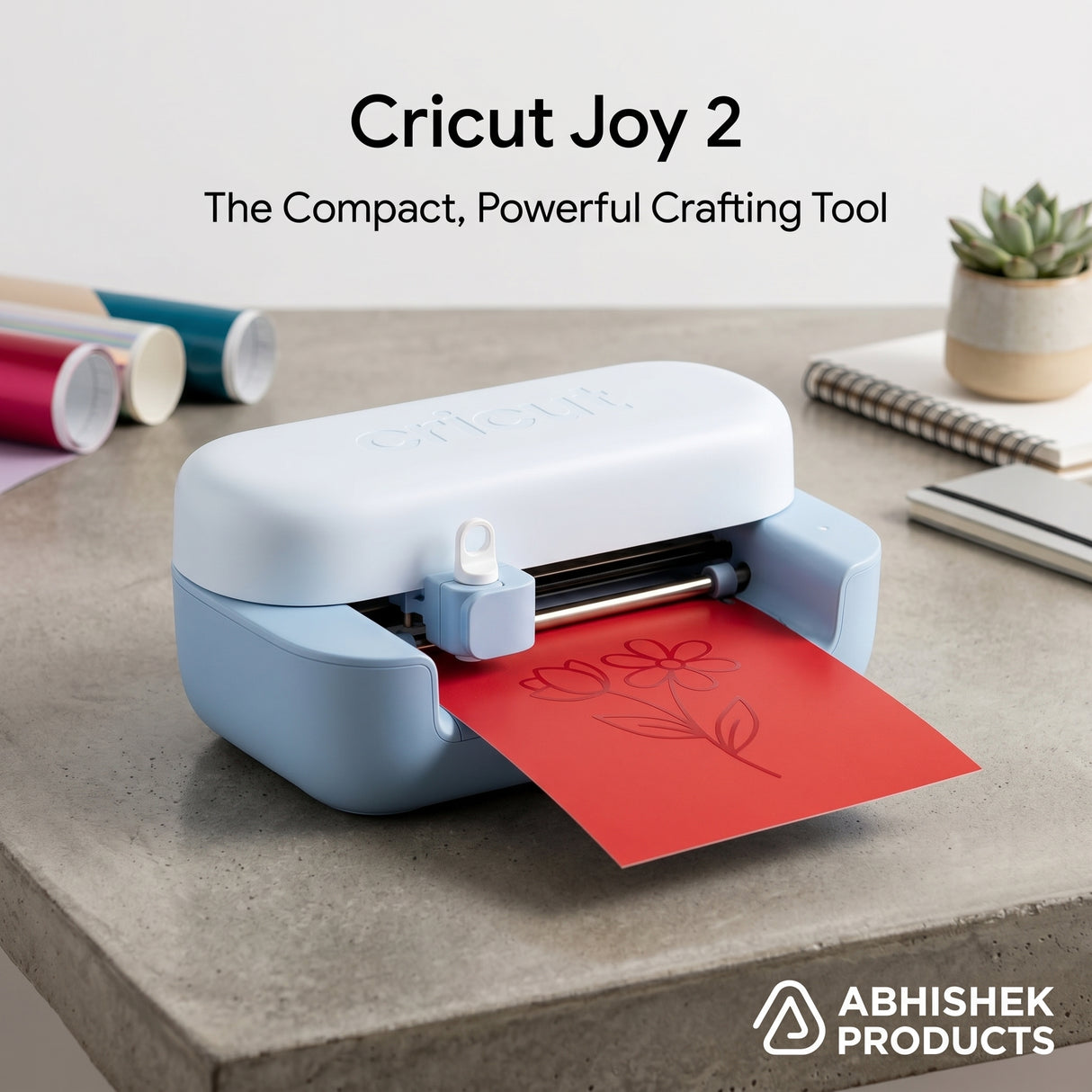 Light blue Cricut Joy 2 machine drawing a flower design on red cardstock paper for DIY crafts.