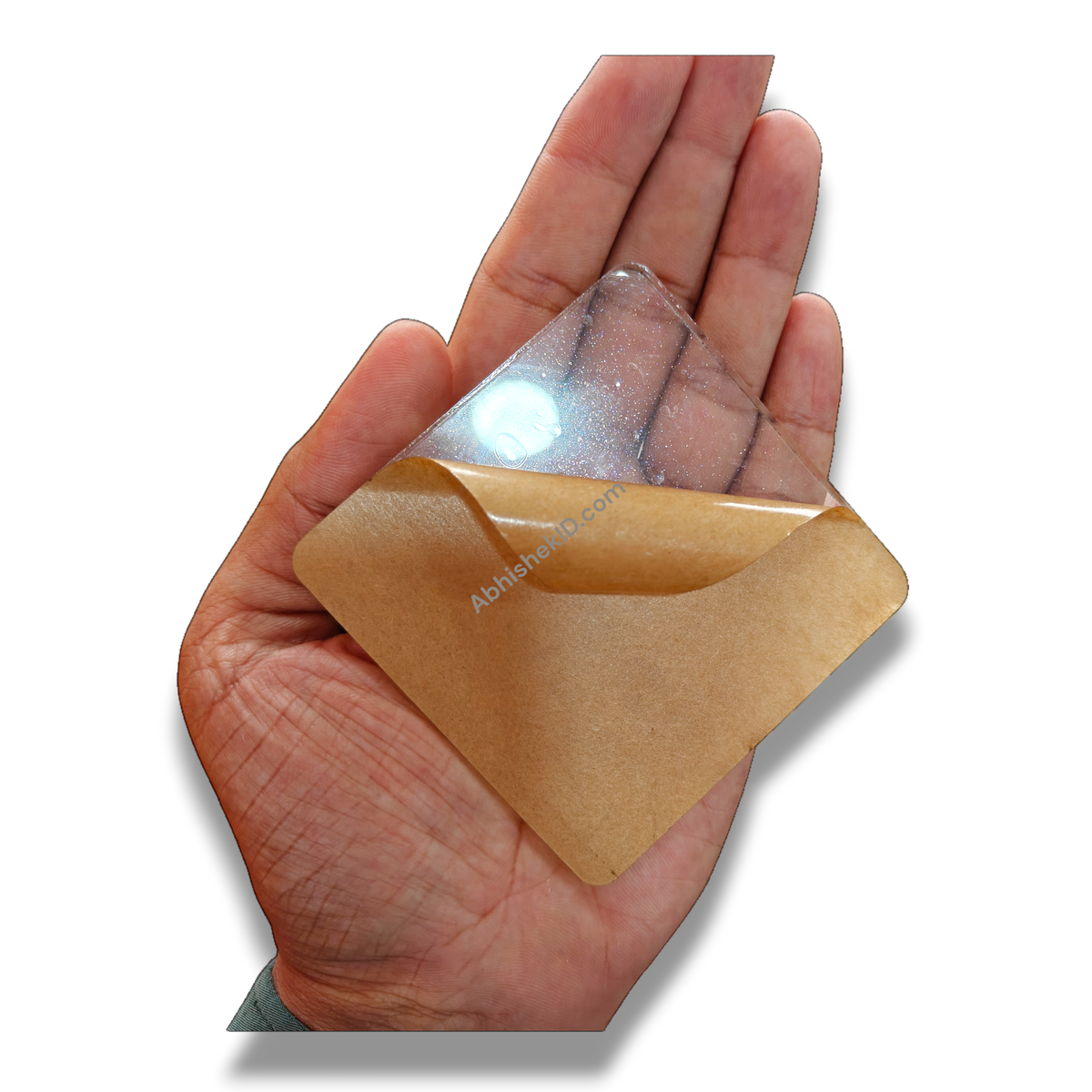 74mm square clear acrylic paperweight DIY blank for inserts, held in hand, with protective film peeling.