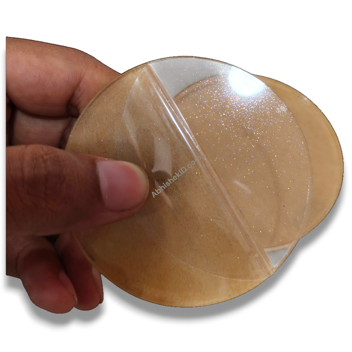 74mm Round Acrylic Paper Weight DIY Set, clear 5mm sparkle gumming, held by hand, for crafting paperweights.