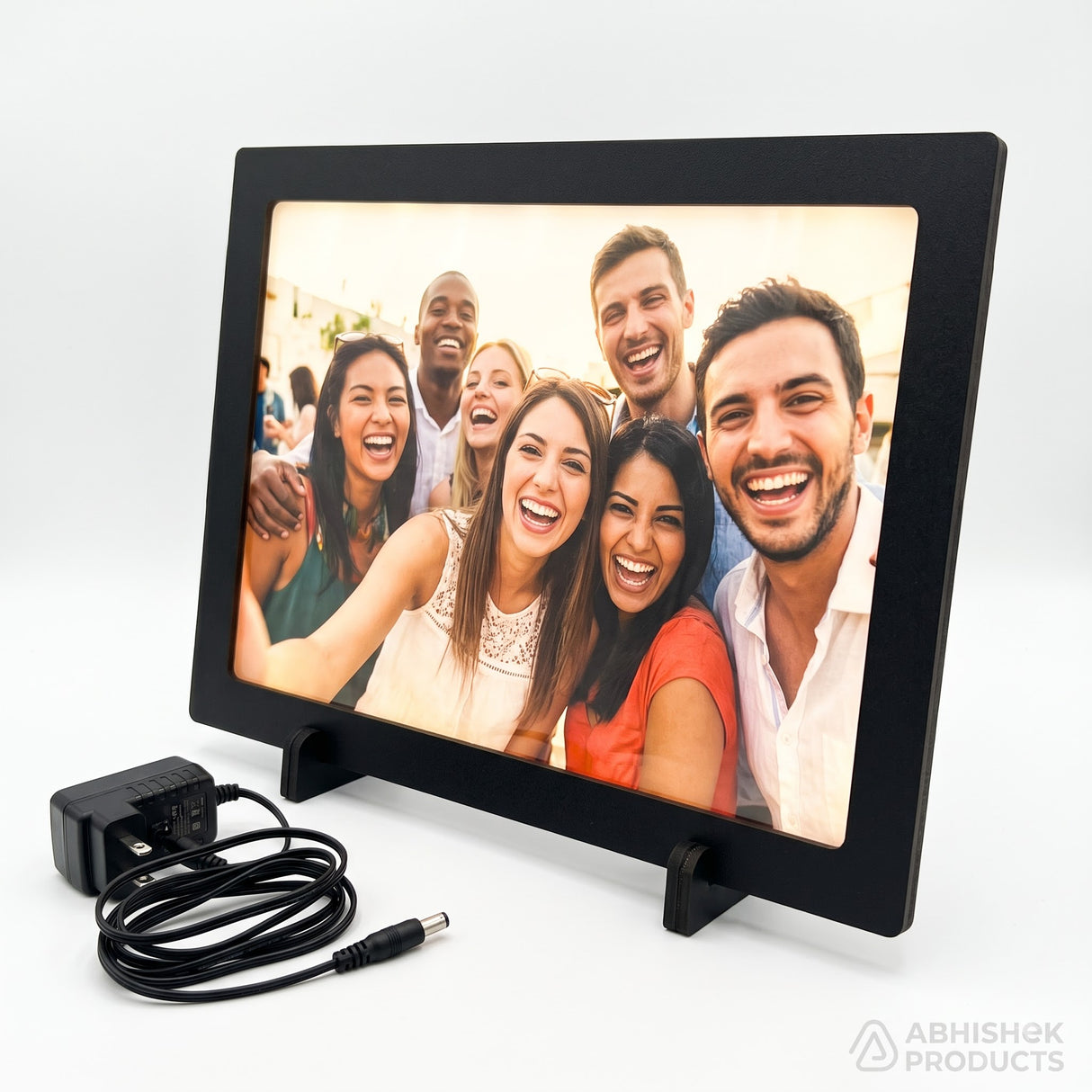 A4 LED Light Frame, black premium MDF, tabletop display of a group selfie, with power adapter.