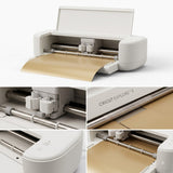 Cricut Explore 5 smart cutting machine, white, with gold vinyl loaded for cutting.