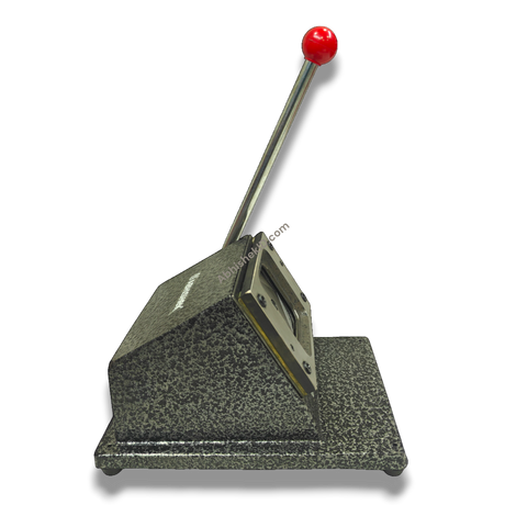61mm Imported Square Die Cutter, heavy-duty metal in speckled gray with a red handle, for fridge magnets & badges.
