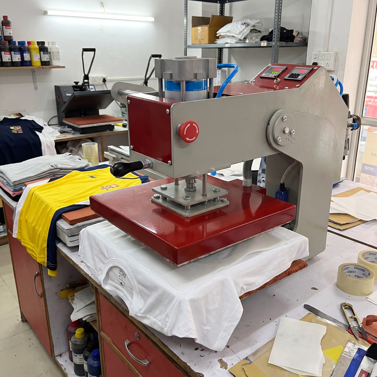 15x15 Automatic Double Bed Sublimation Heat Press, gray and red metal, pressing a white t-shirt.