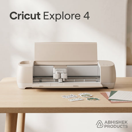 Beige Cricut Explore 4 Smart Cutting Machine on a wooden desk with paper sheets for custom sticker making.