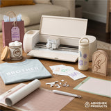Cream Cricut Explore 4 Smart Cutting Machine with vinyl, used for DIY crafting custom shirts, stickers, and gifts.