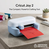 Light blue Cricut Joy 2 machine drawing a flower design on red cardstock paper for DIY crafts.