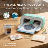 Mint green Cricut Joy 2 cutting paper designs next to custom cotton pouch and ceramic mug for DIY crafting.