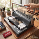 A4 21-Slot Metal Comb Binding Machine in dark gray, binding an annual report for office use.