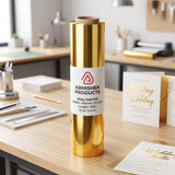 12 Inch x 112 Meter Gold Foil Metallic Roll (LaserJet) on a desk with wedding invitations.