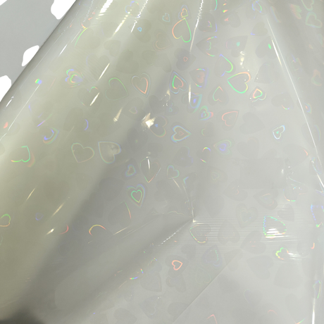 Holographic Heart Thermal Lamination Roll, clear film with iridescent heart pattern, 330MM x 100M x 27 Micron.