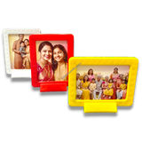 Colorful magnetic tabletop frames 3x4 inch. White, red, yellow frames displaying family portraits. Home decor.