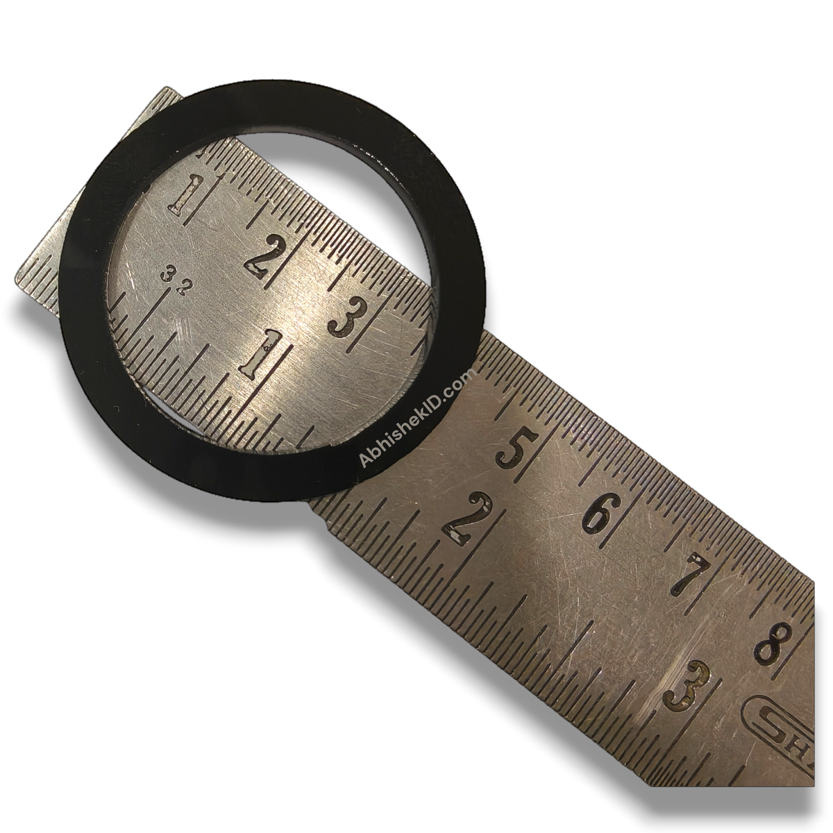 Button Badge Rings 58mm 44mm die height washer spacer, black plastic, on a metal ruler for size reference.